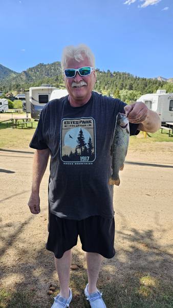 A fishing catch held up at the campground