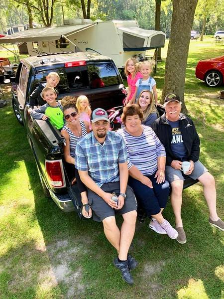 Gary gathered with family around a truck