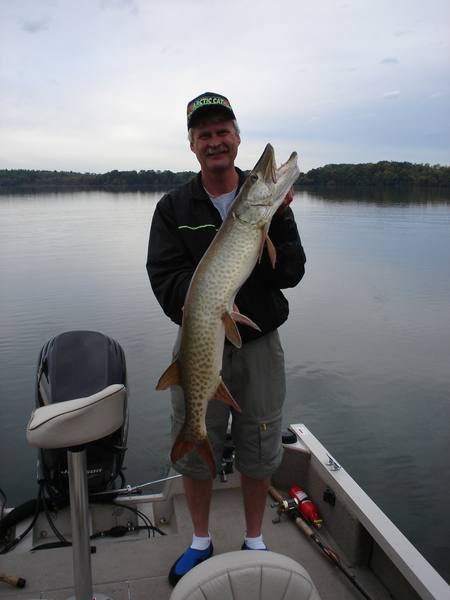 Gary holding a fish from the boat