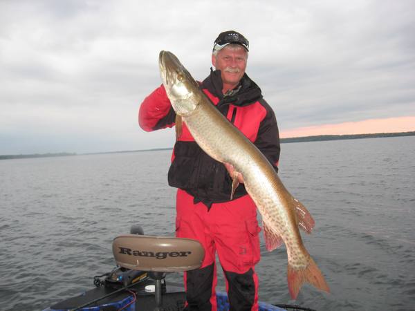 Gary holding a musky while fishing on the lake