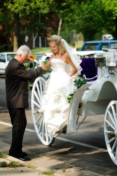 Gary sharing a wedding-day moment beside a carriage