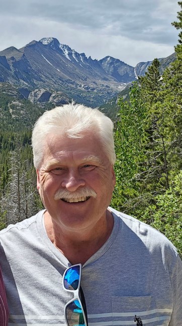 Gary Blumenschein smiling in the mountains